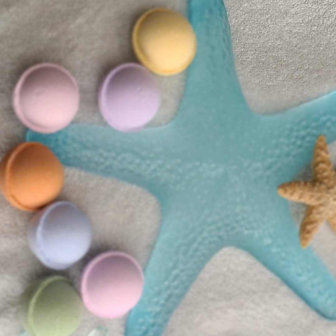 Colorful bath bombs and bombinos on a beach-inspired backdrop