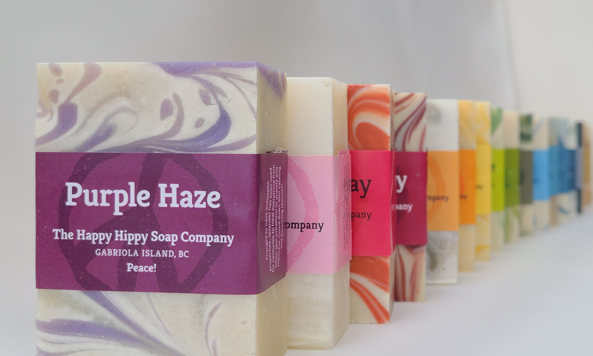 Stack of handcrafted Happy Hippy soap bars including Purple Haze, packaged and labeled, Gabriola Island BC